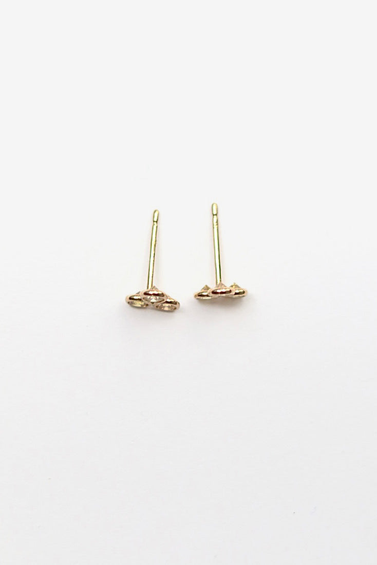 Gold earrings on a white background