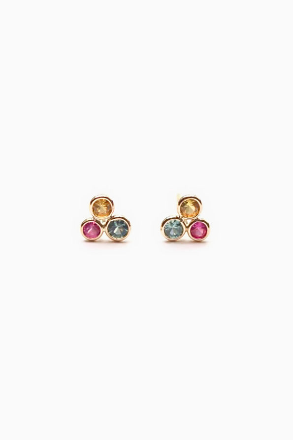 Pair of gold earrings with gemstones on a white background