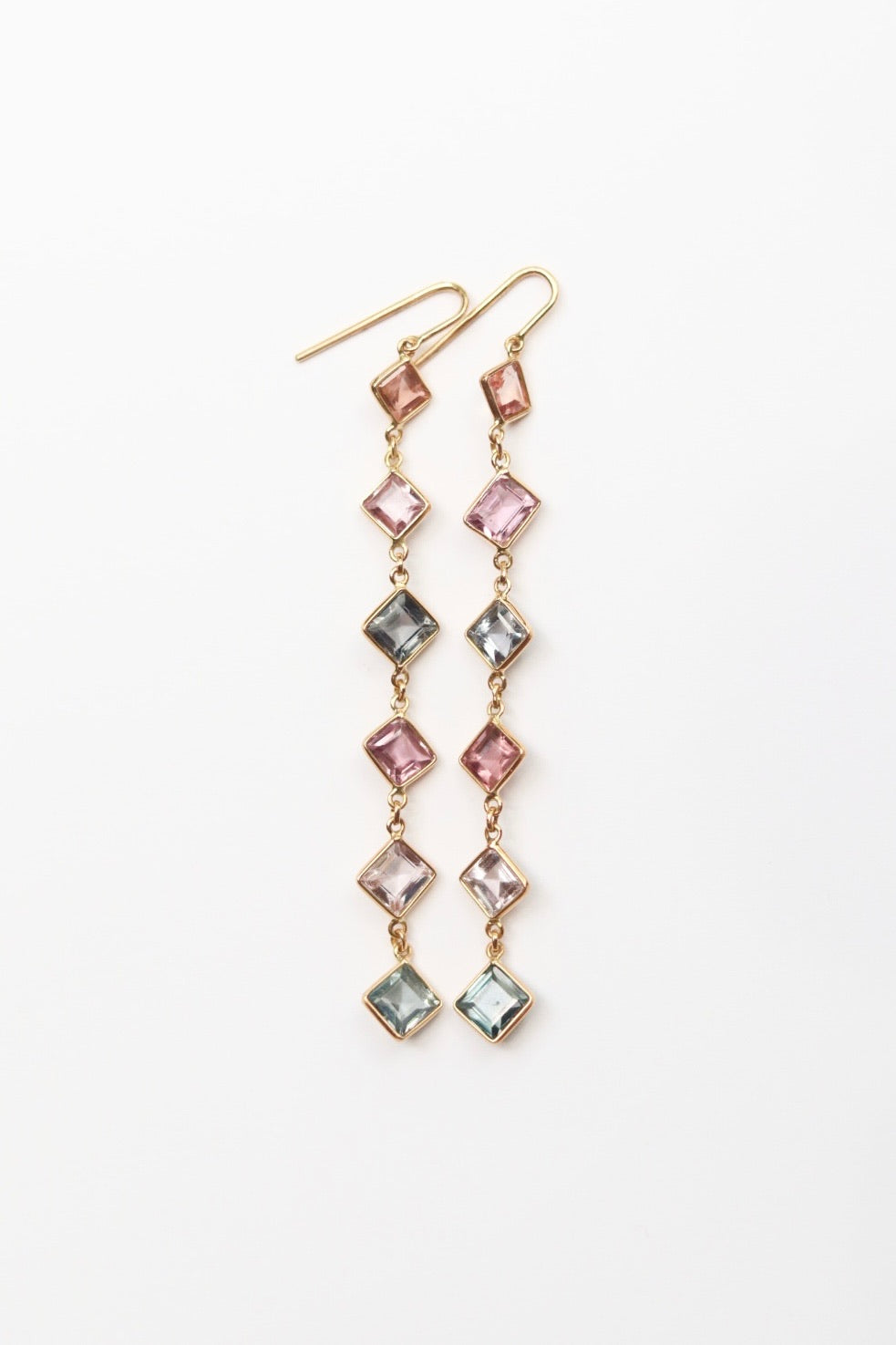 Multicolored diamond gemstone earrings on a white background