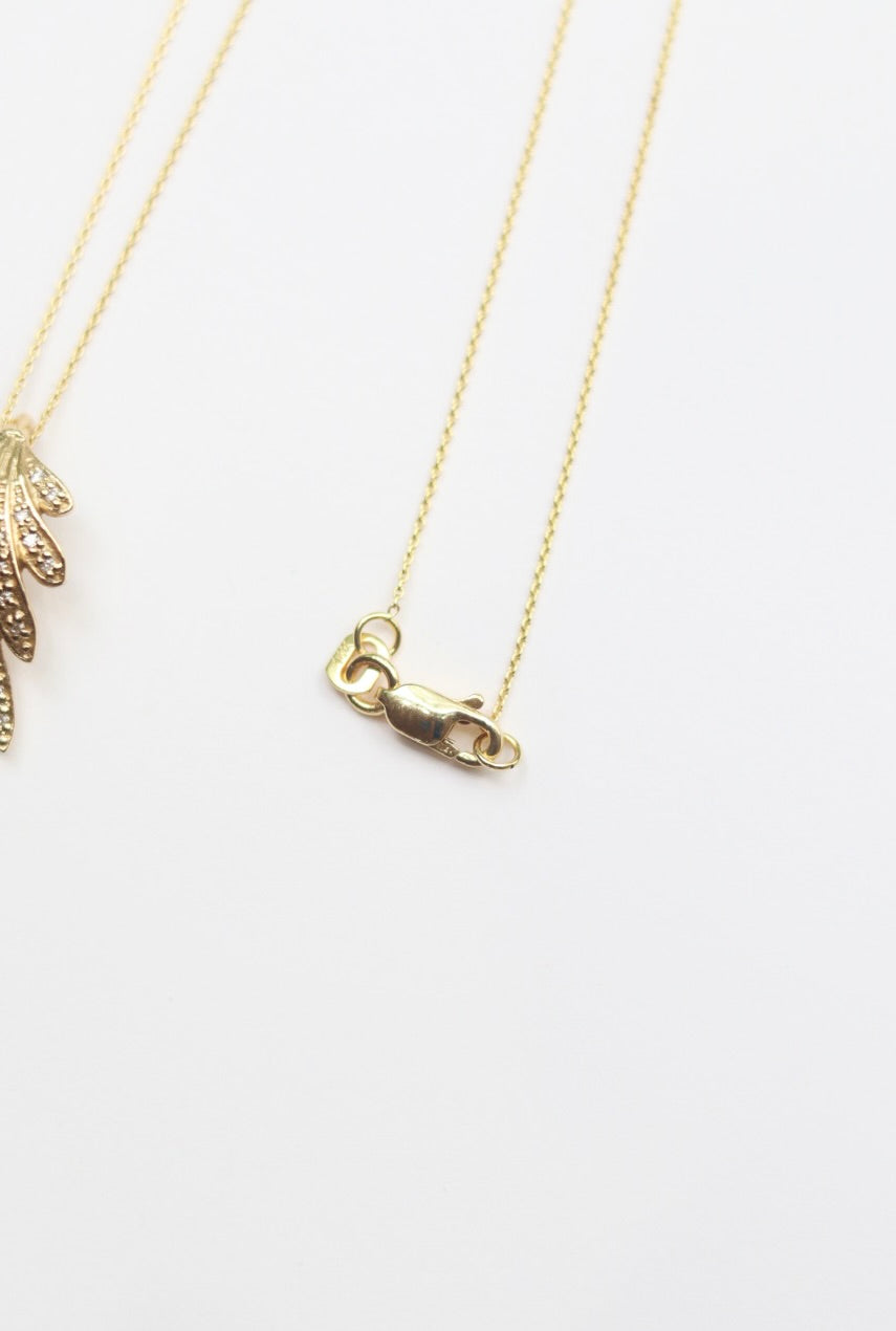 Gold necklace with a clasp on a white background