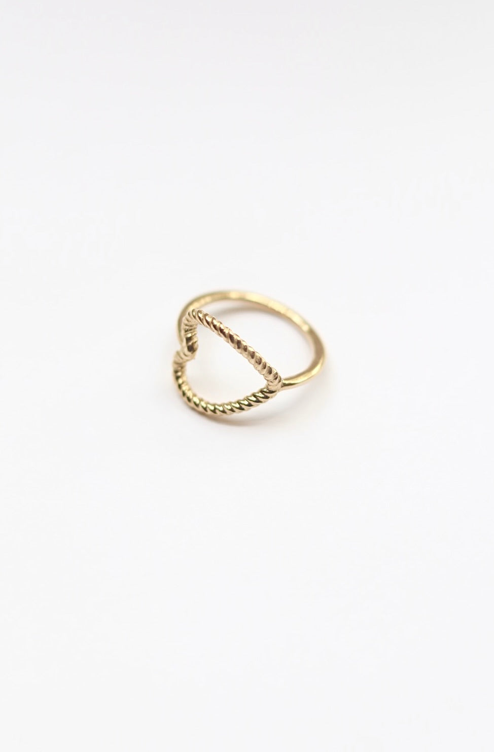 Gold ring with a chain design on a white background