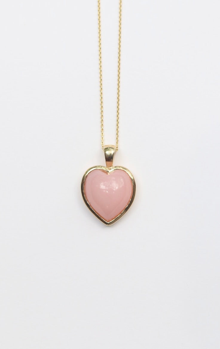 Necklace with a pink heart-shaped pendant on a white background