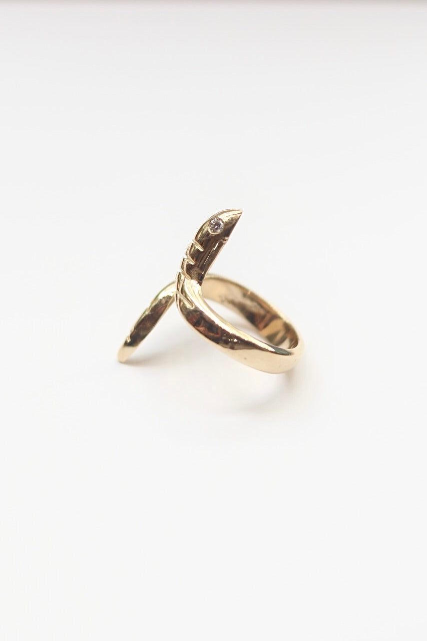 Gold snake ring on a white background