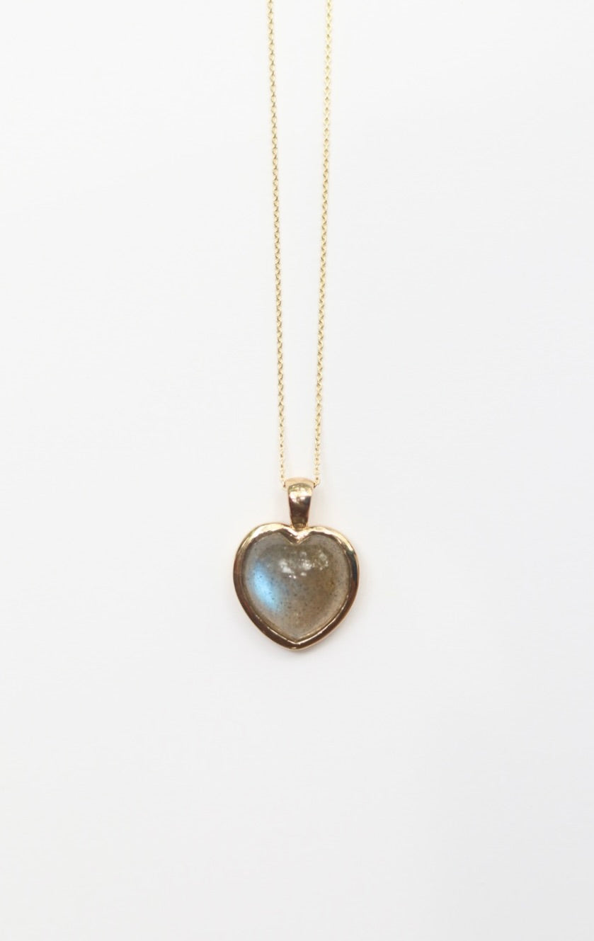 Heart-shaped labradorite pendant necklace on a white background