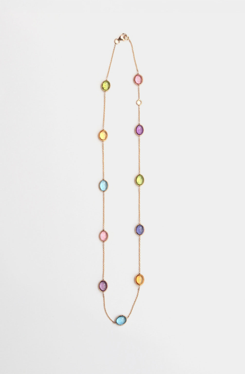 Necklace with multicolored oval beads on a white background