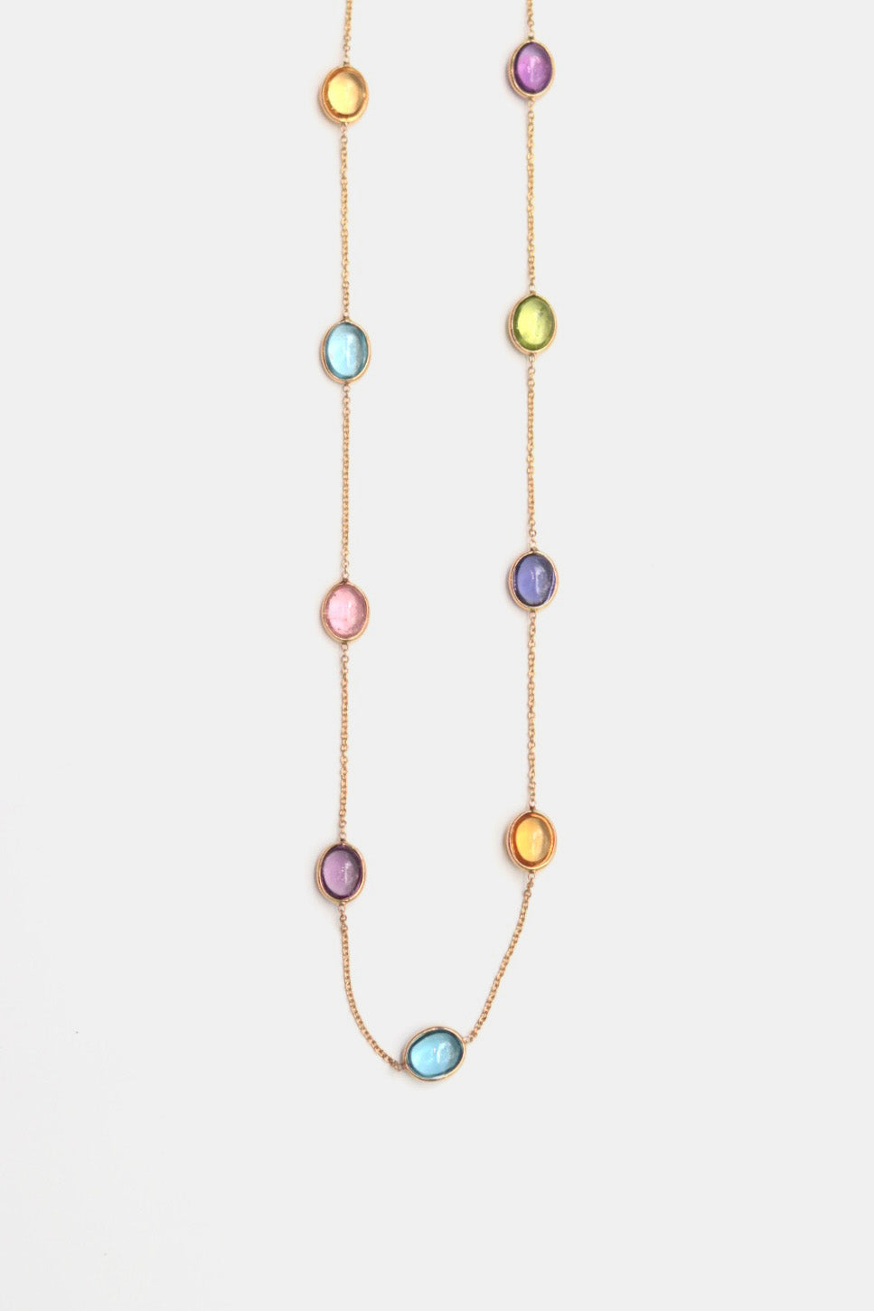 Necklace with multicolored oval gemstones on a white background