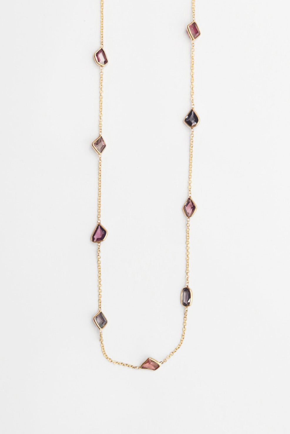 Necklace with purple gemstones on a white background