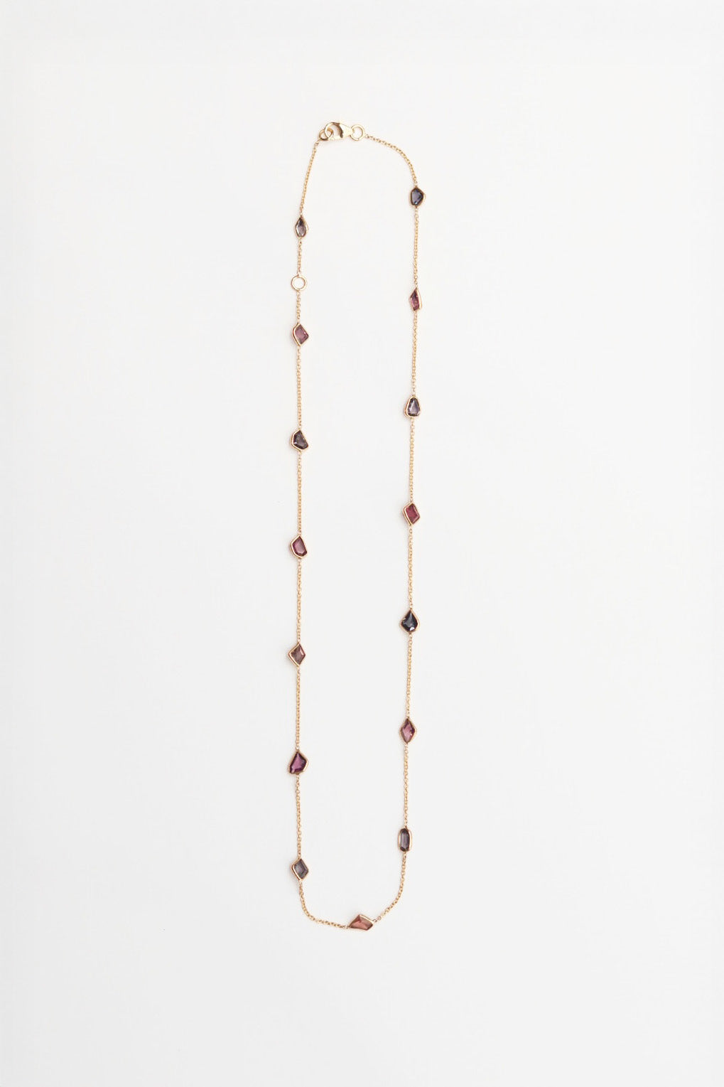 Long necklace with purple and brown beads on a white background