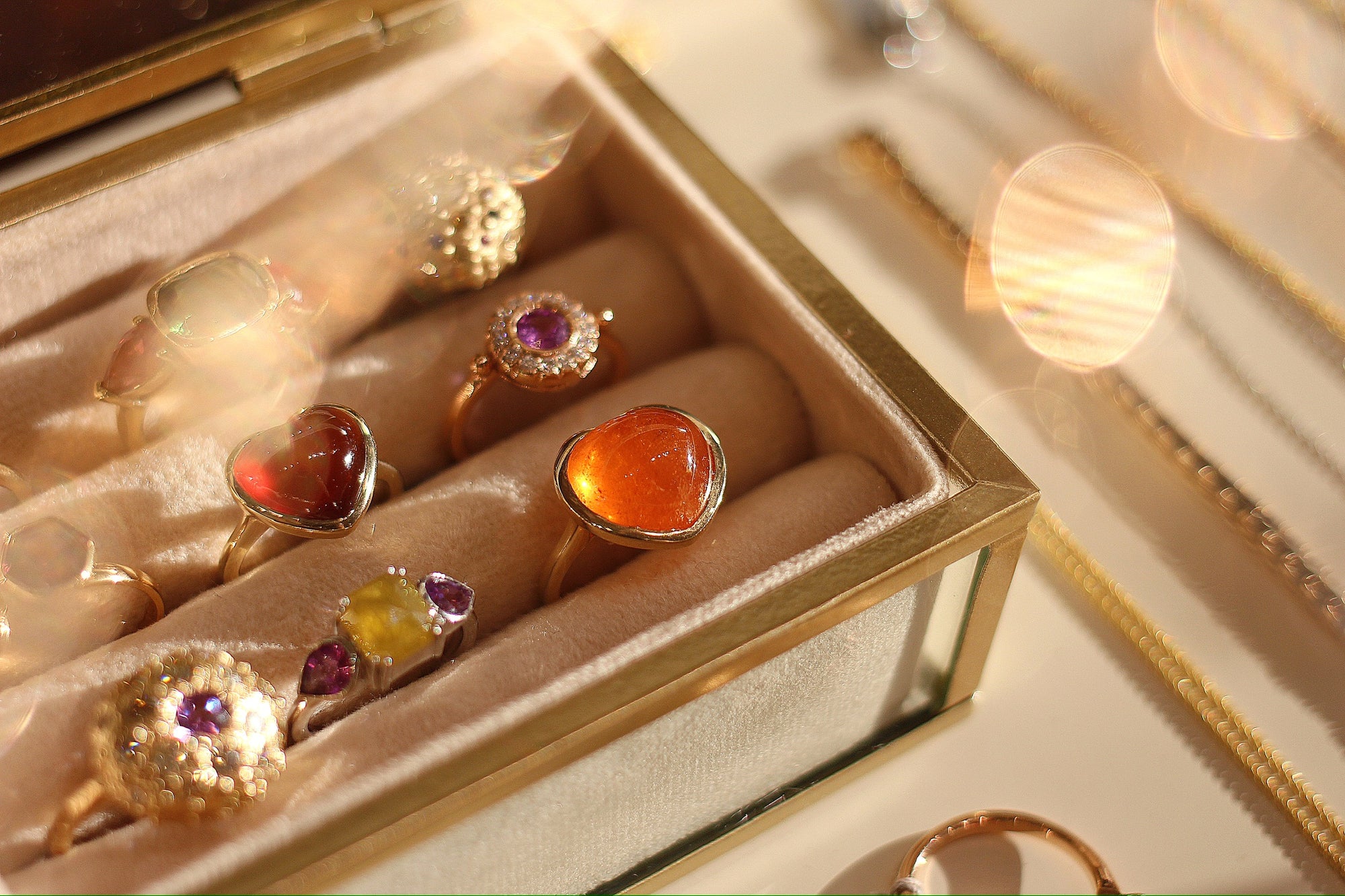 Gold rings with colorful gemstones in a jewelry box