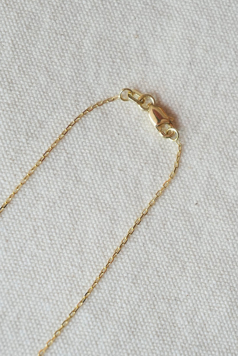 Gold chain on a textured gray background
