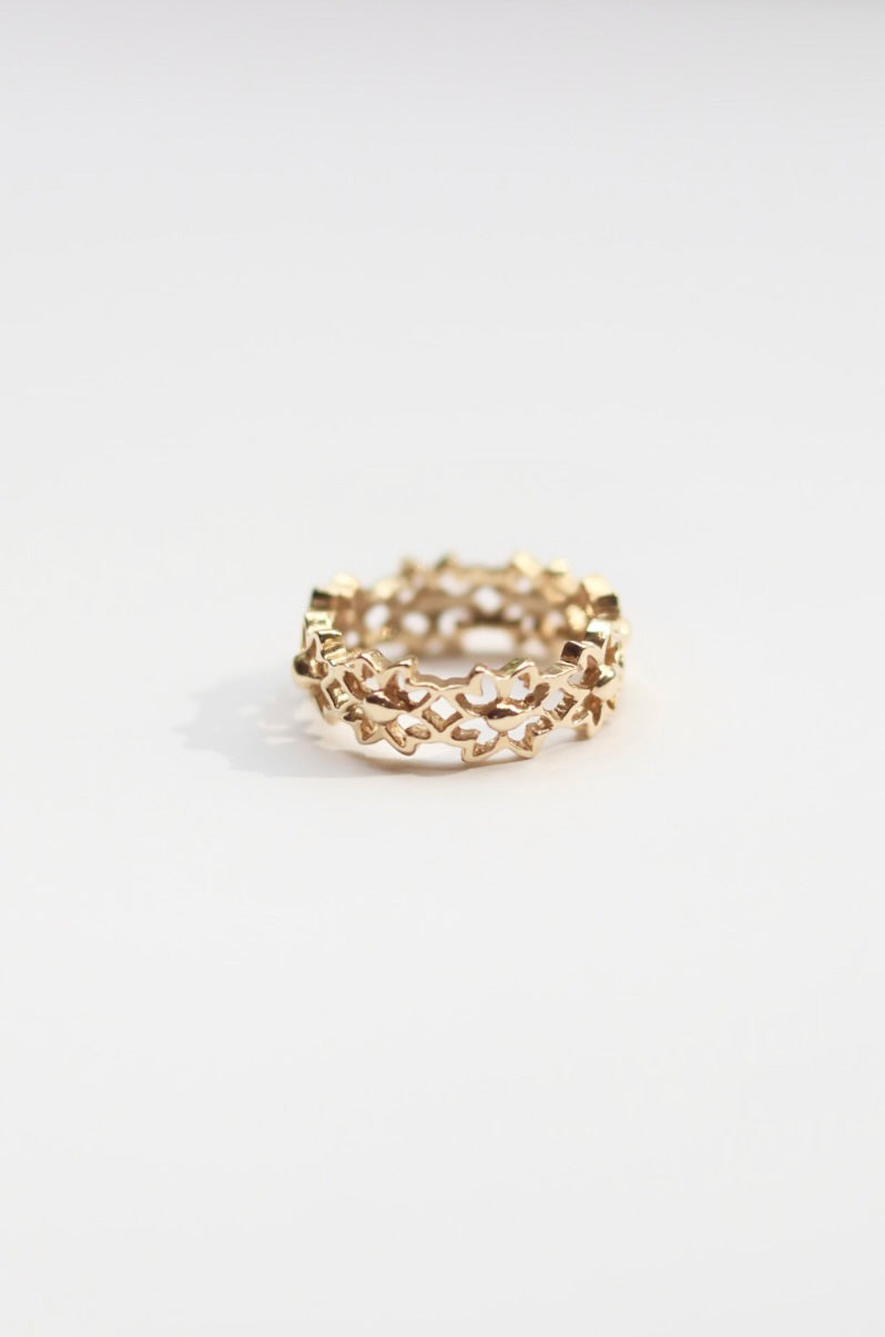 Gold flower ring on a white background