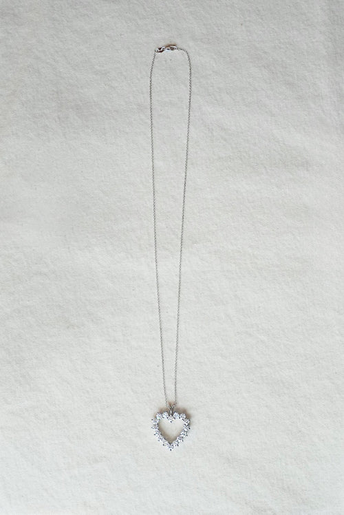 Necklace with a heart-shaped pendant on a light gray background