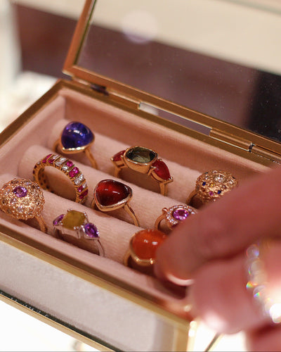 Set of colorful gemstone rings in a jewelry box